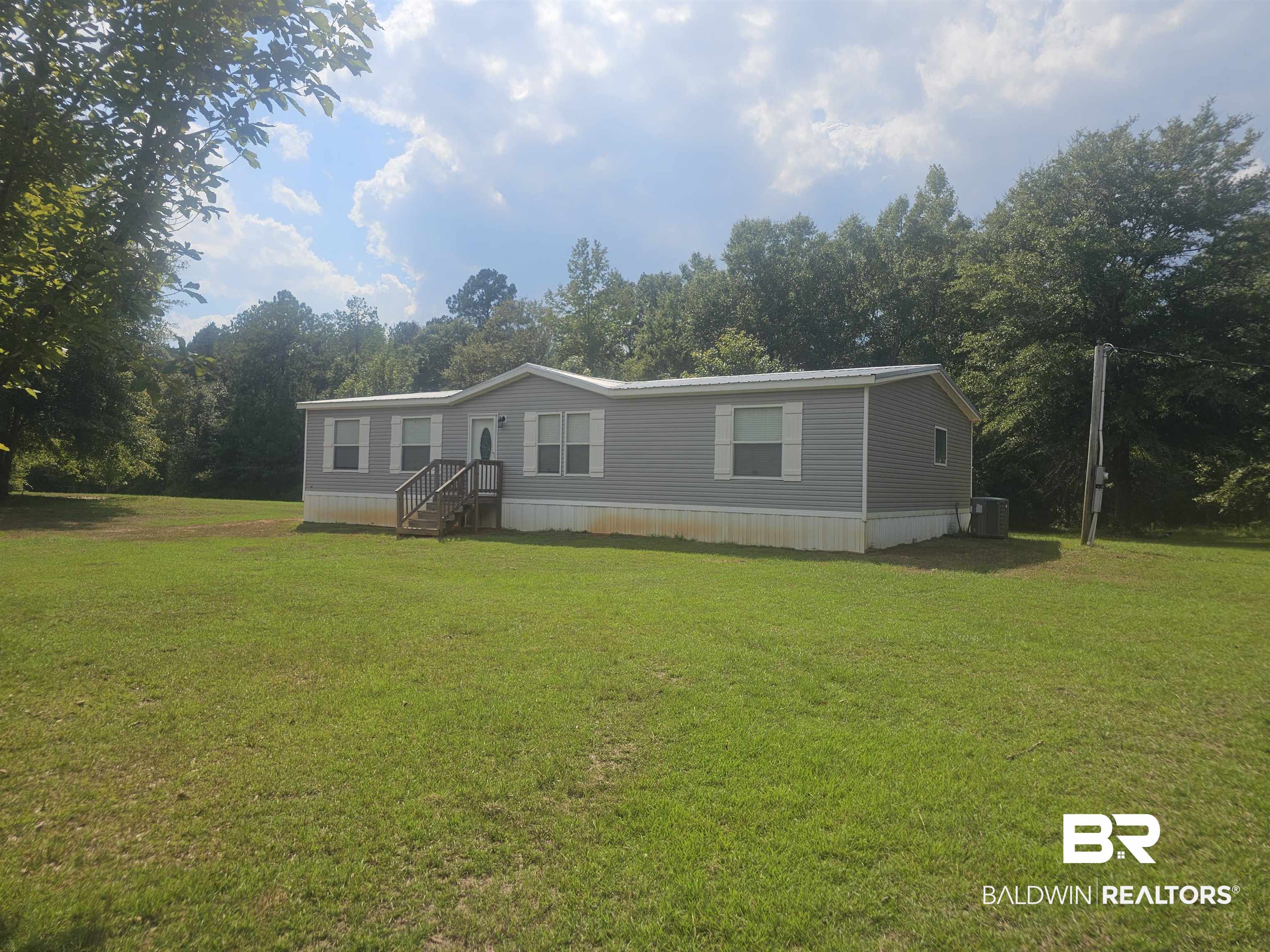 1863 Wait Road Monroeville, AL 36460 - Photo 35 of 38 Manufactured / mobile home featuring a front lawn and central AC unit