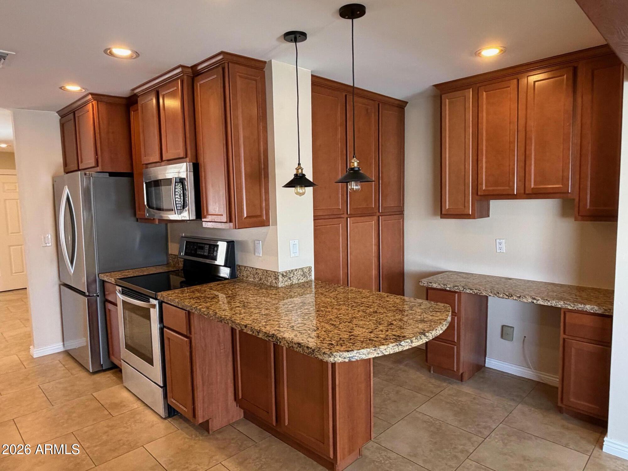 6036 North 8th Street Phoenix, AZ 85014 - Photo 11 of 37 a kitchen with stainless steel appliances granite countertop a stove refrigerator sink and microwave
