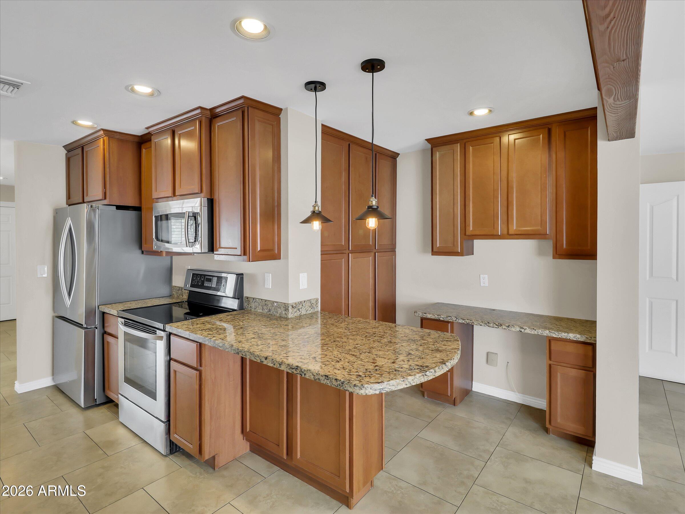 6036 North 8th Street Phoenix, AZ 85014 - Photo 11 of 31 a kitchen with stainless steel appliances granite countertop a sink stove and refrigerator