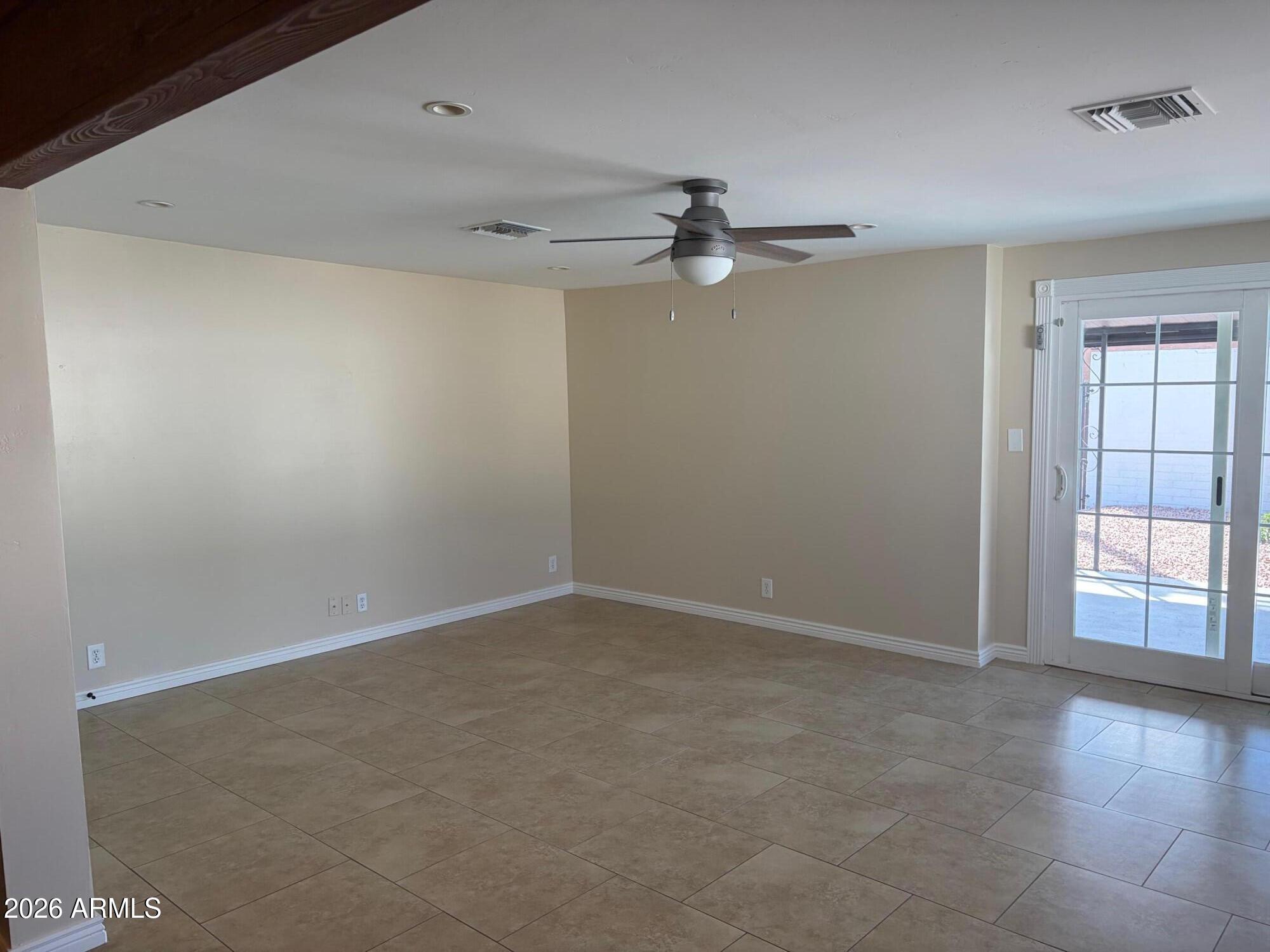 6036 North 8th Street Phoenix, AZ 85014 - Photo 14 of 37 an empty room with windows and fan