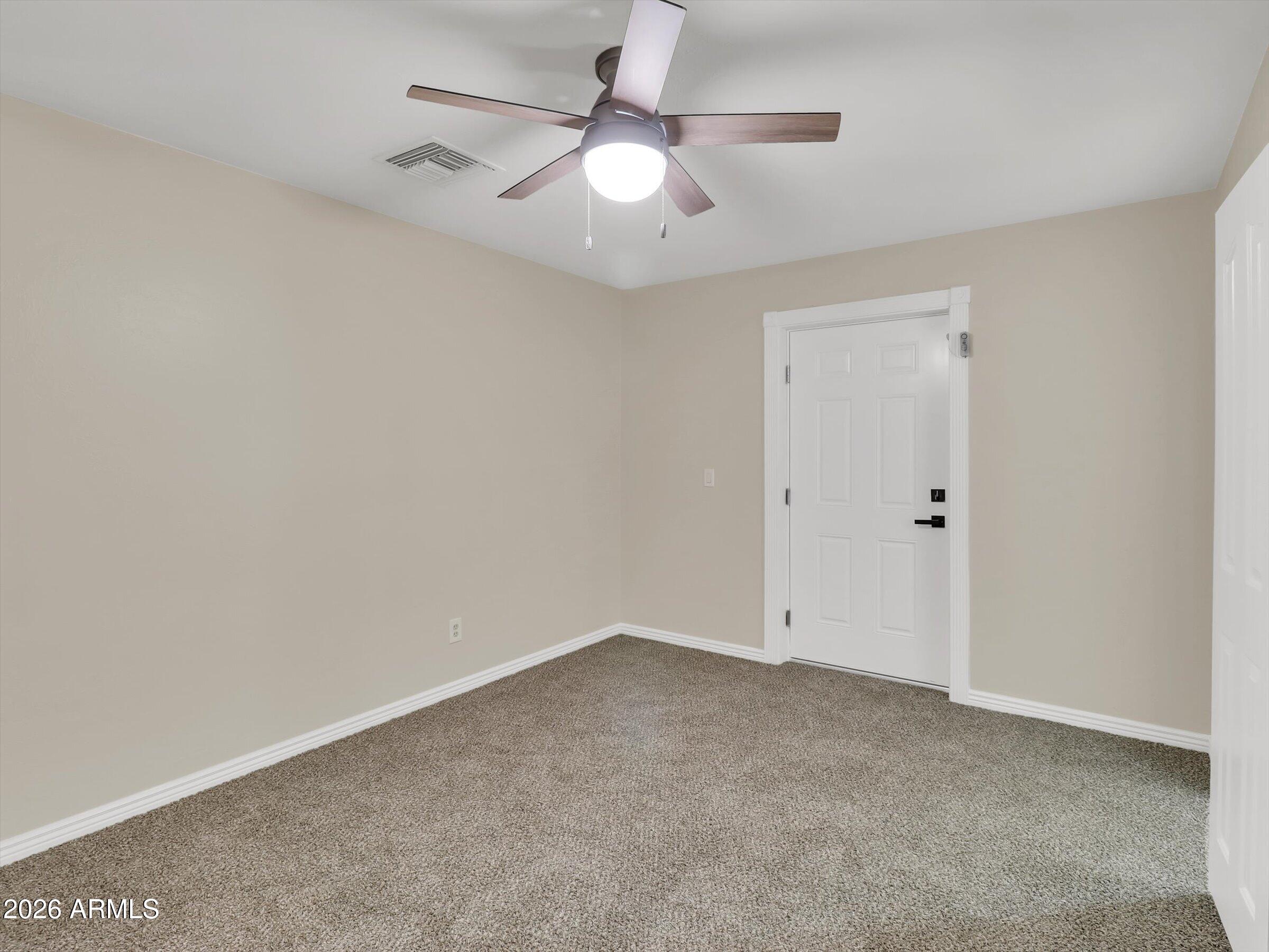 6036 North 8th Street Phoenix, AZ 85014 - Photo 18 of 31 an empty room with a ceiling fan and a window