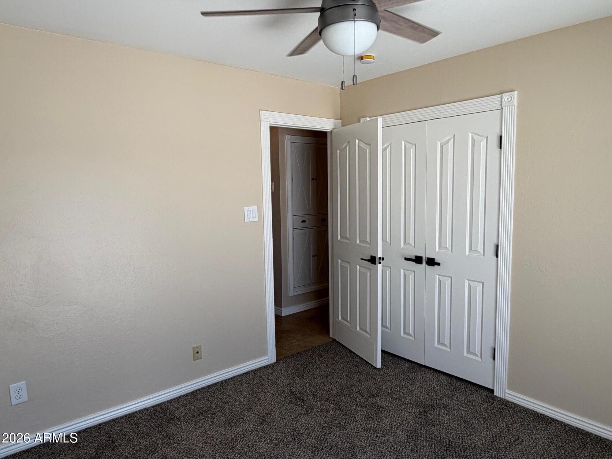 6036 North 8th Street Phoenix, AZ 85014 - Photo 23 of 37 an empty room with a ceiling fan
