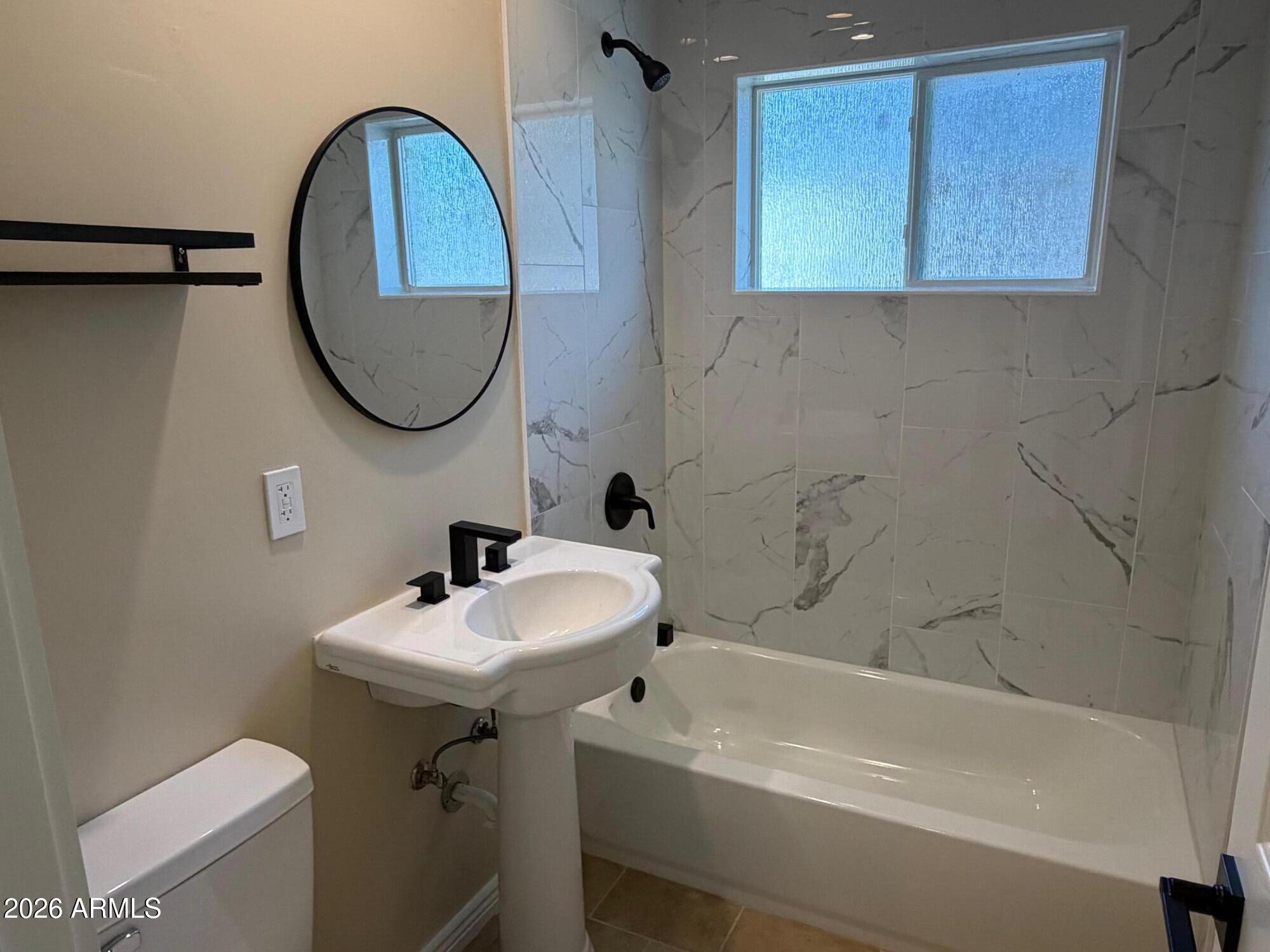6036 North 8th Street Phoenix, AZ 85014 - Photo 25 of 37 a bathroom with a sink a toilet and a bathtub