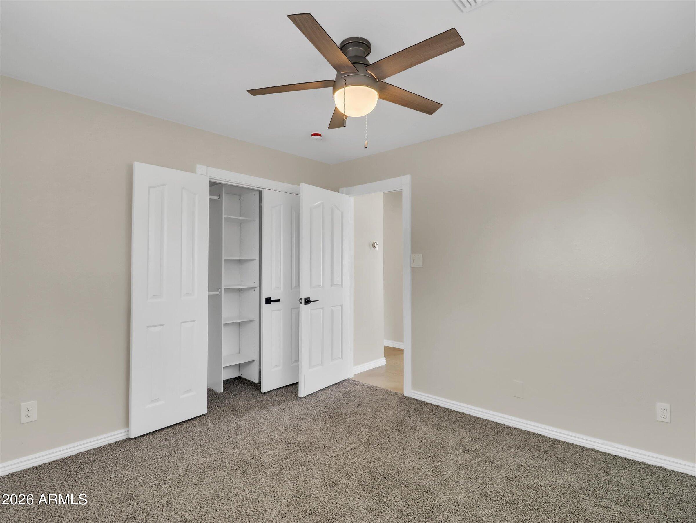 6036 North 8th Street Phoenix, AZ 85014 - Photo 28 of 31 an empty room with closet and fan