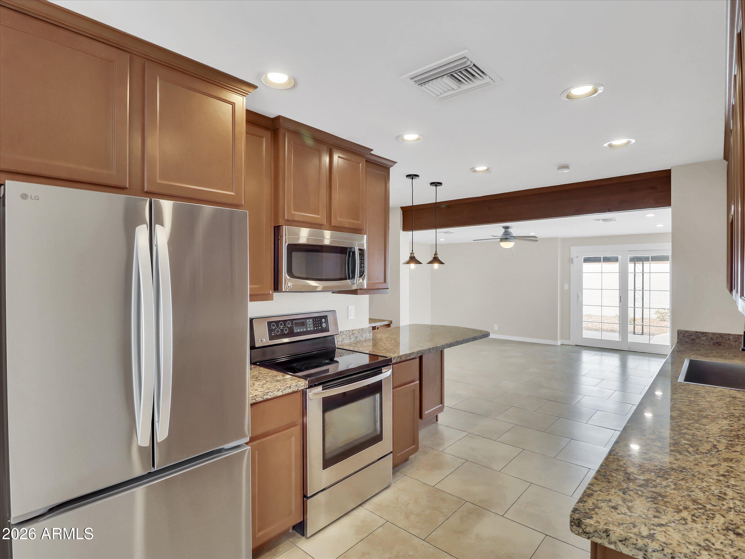 6036 North 8th Street Phoenix, AZ 85014 - Photo 7 of 31 a kitchen with stainless steel appliances a refrigerator and a stove top oven