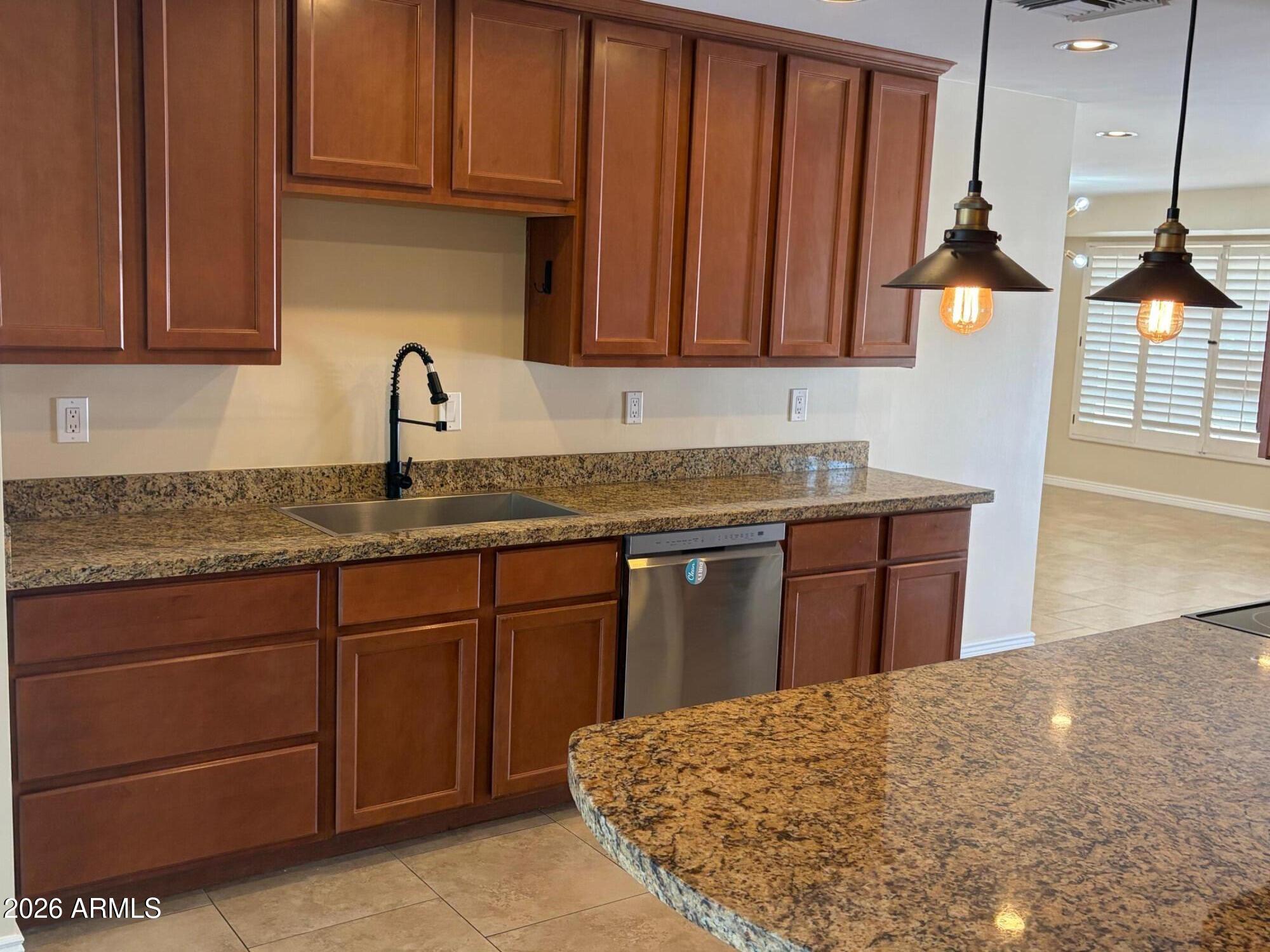 6036 North 8th Street Phoenix, AZ 85014 - Photo 9 of 37 a kitchen with granite countertop a sink stainless steel appliances and cabinets
