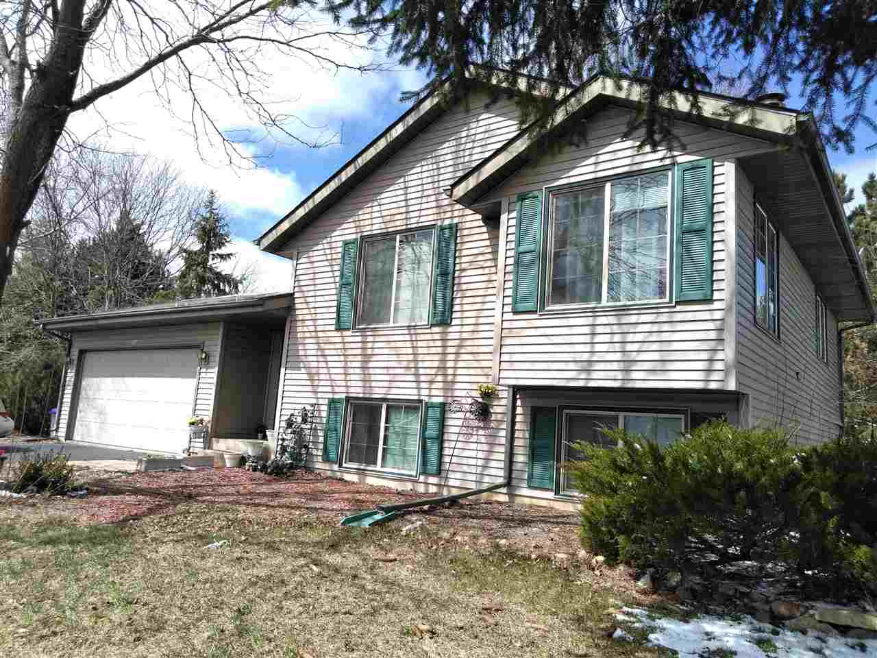 a front view of a house with yard and garage