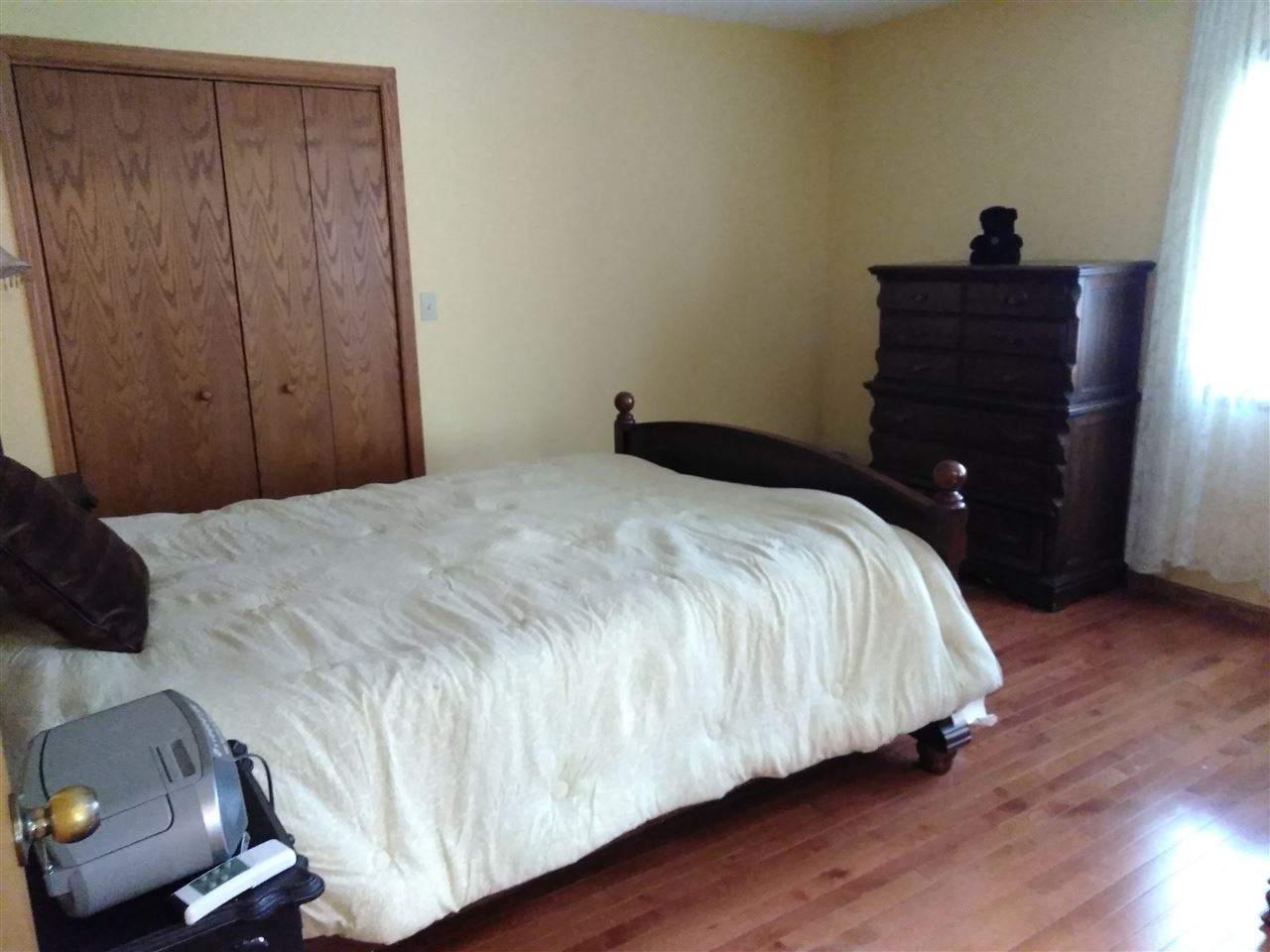 1039 South Trainer Road Rockford, IL 61108 - Photo 7 of 18 a bedroom with a bed and a dresser