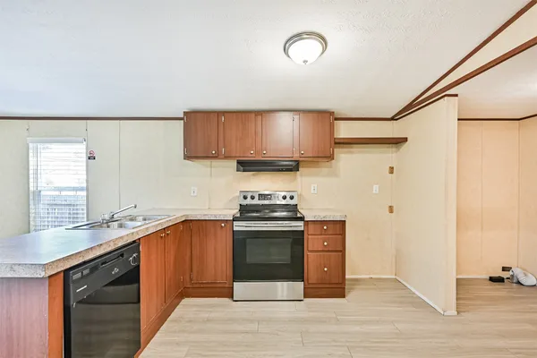 a kitchen with stainless steel appliances granite countertop a sink and stove top oven