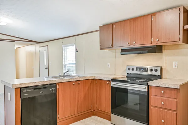 a kitchen with stainless steel appliances granite countertop a sink stove and cabinets