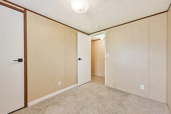 a bathroom with a granite countertop sink a toilet and shower