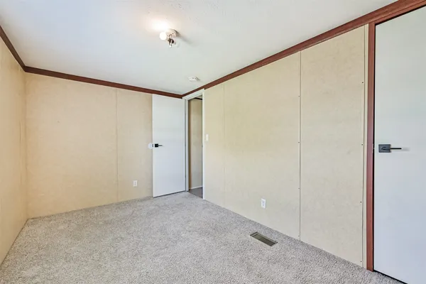 a backyard of a house with lots of green space and fountain