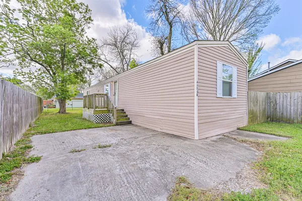 a white house that has a tree in front of the house