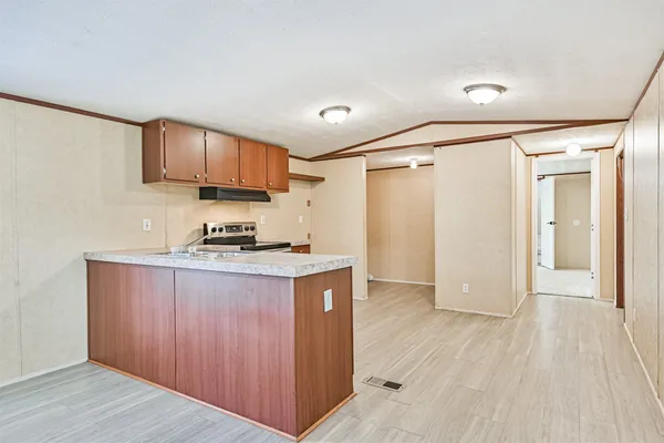 a kitchen with a sink a refrigerator and cabinets