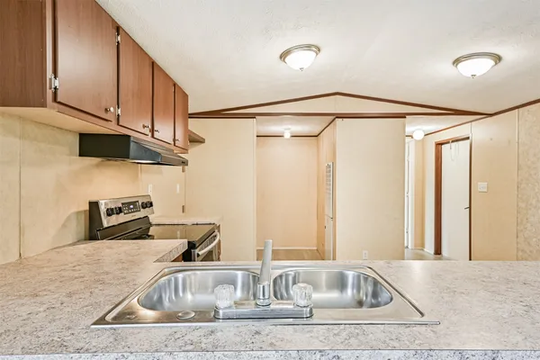 a kitchen with stainless steel appliances granite countertop a stove and a sink