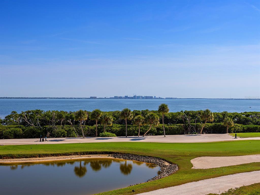 3040 Grand Bay Boulevard, Unit 213 Longboat Key, FL 34228 - Photo 11 of 44 a view of a lake with a houses in the background
