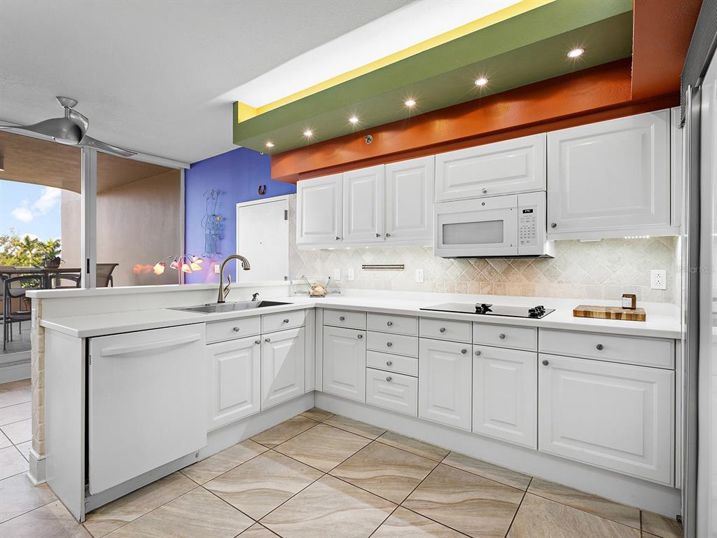 3040 Grand Bay Boulevard, Unit 213 Longboat Key, FL 34228 - Photo 14 of 44 a kitchen with cabinets appliances and a sink