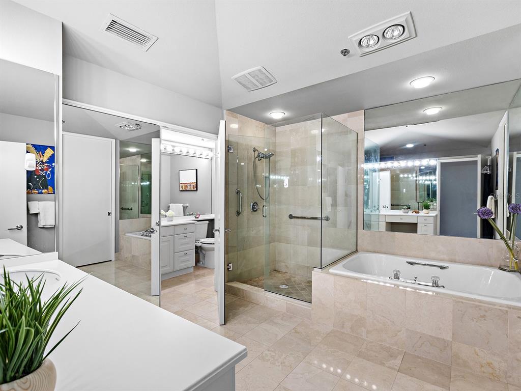 3040 Grand Bay Boulevard, Unit 213 Longboat Key, FL 34228 - Photo 21 of 44 a large spacious bathroom with a large tub shower and sink