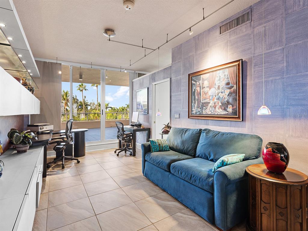 3040 Grand Bay Boulevard, Unit 213 Longboat Key, FL 34228 - Photo 25 of 44 a living room with furniture and wooden floor