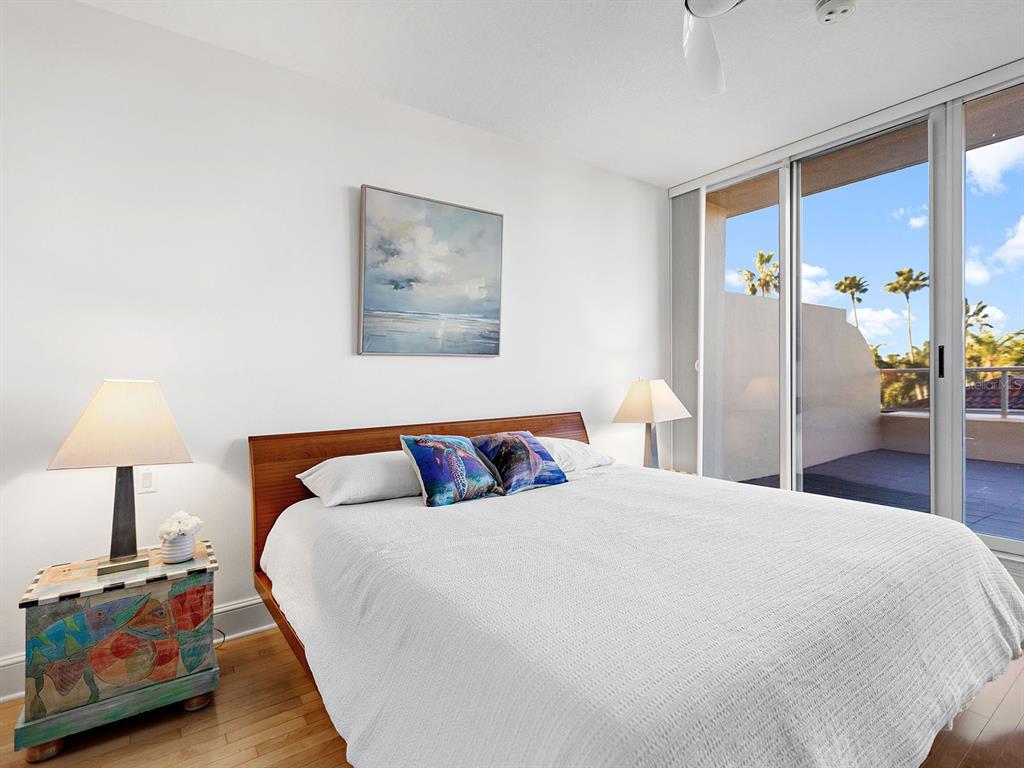 3040 Grand Bay Boulevard, Unit 213 Longboat Key, FL 34228 - Photo 27 of 44 a bedroom with a bed and a lamp