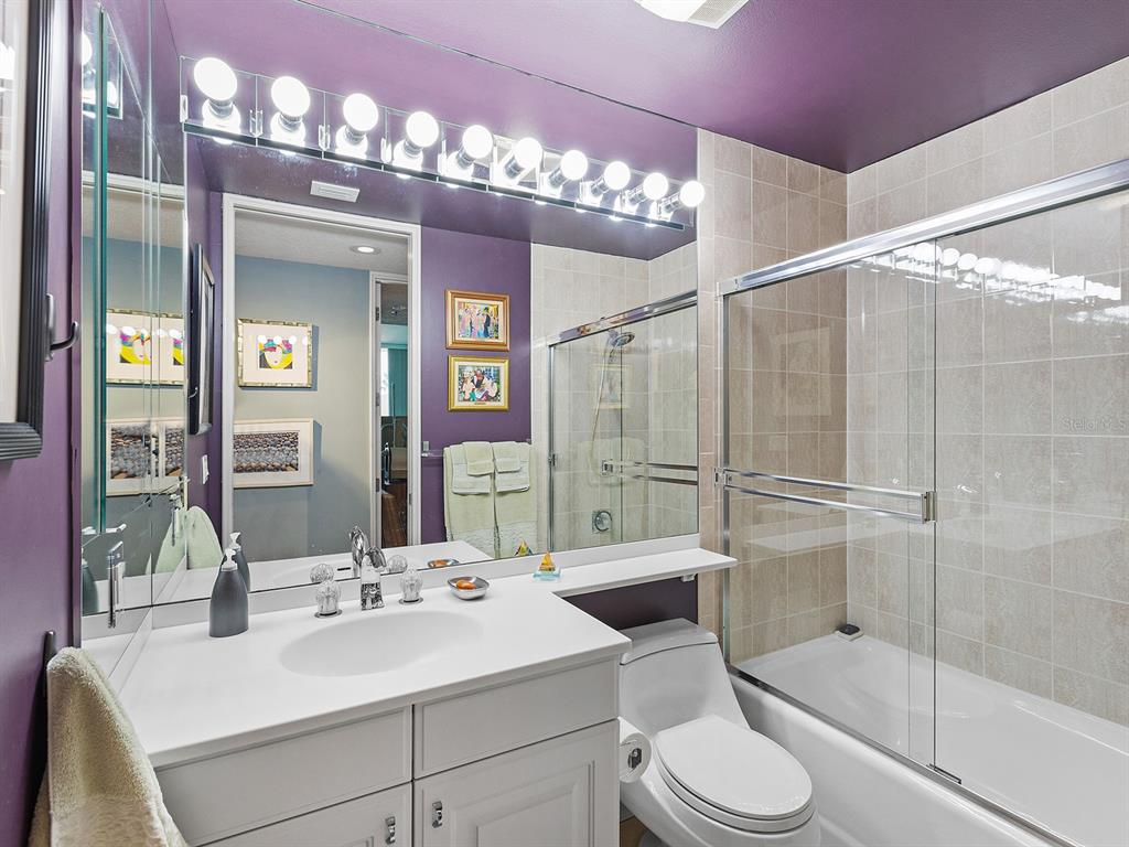 3040 Grand Bay Boulevard, Unit 213 Longboat Key, FL 34228 - Photo 32 of 44 a bathroom with a sink a toilet and shower