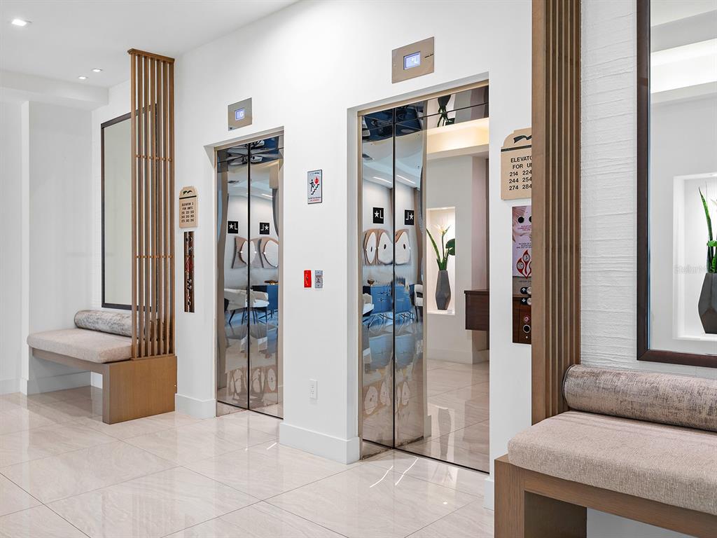 3040 Grand Bay Boulevard, Unit 213 Longboat Key, FL 34228 - Photo 4 of 44 a living room with furniture and a fireplace