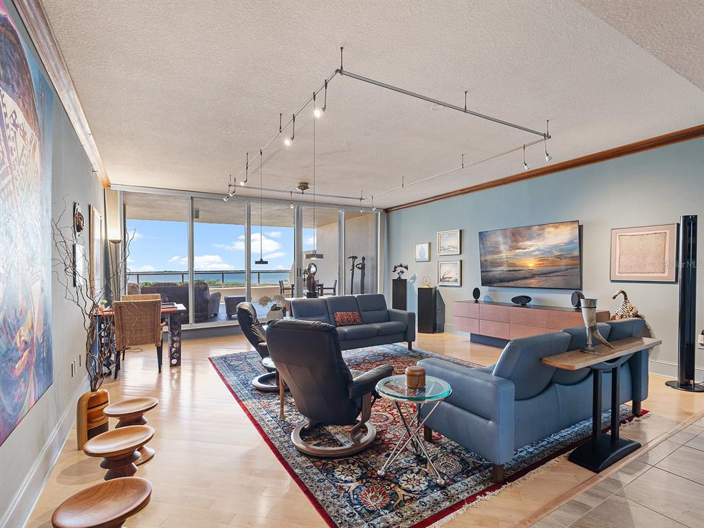 3040 Grand Bay Boulevard, Unit 213 Longboat Key, FL 34228 - Photo 7 of 44 a living room with furniture and a flat screen tv