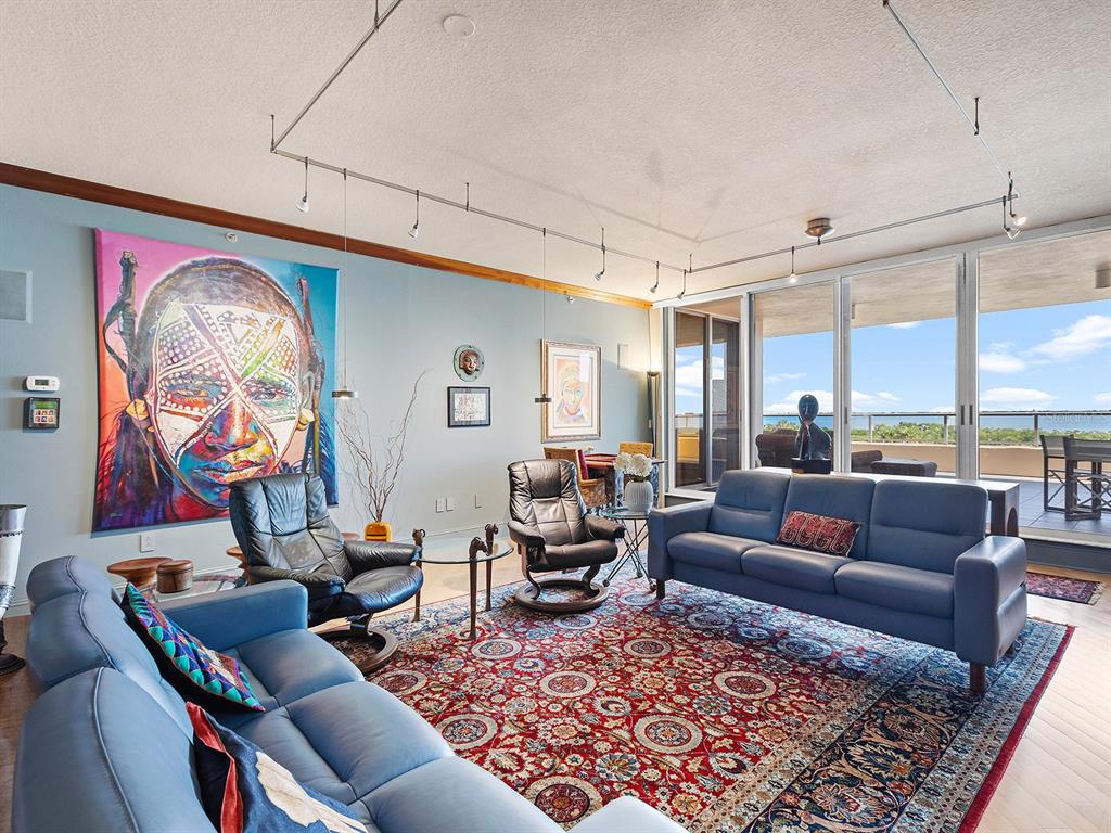 3040 Grand Bay Boulevard, Unit 213 Longboat Key, FL 34228 - Photo 8 of 44 a living room with furniture and a rug