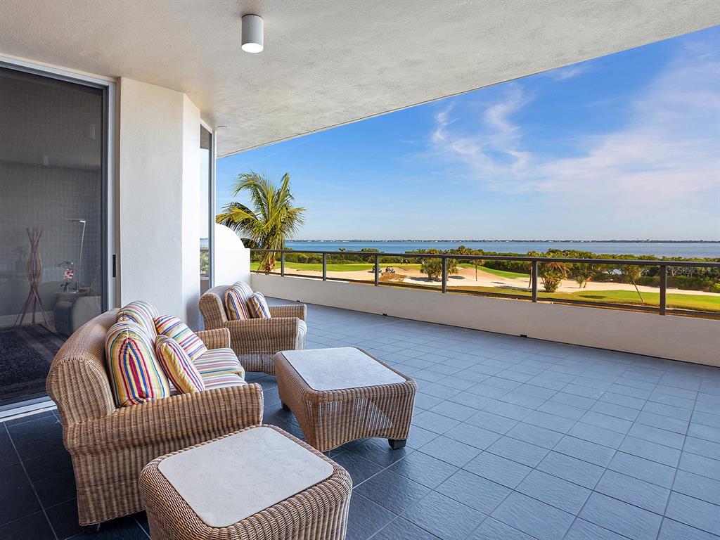 3040 Grand Bay Boulevard, Unit 213 Longboat Key, FL 34228 - Photo 9 of 44 a living room with couches and a table