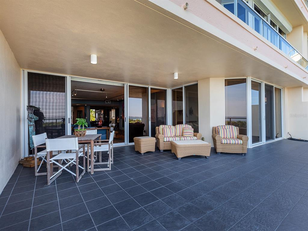 3040 Grand Bay Boulevard, Unit 213 Longboat Key, FL 34228 - Photo 10 of 44 a outdoor space with patio furniture and potted plants