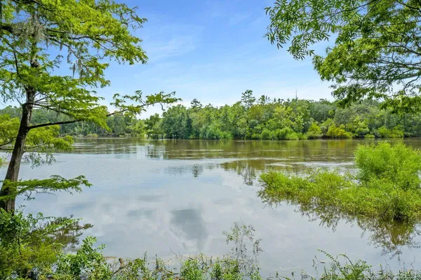 a view of a lake with a house in the background
