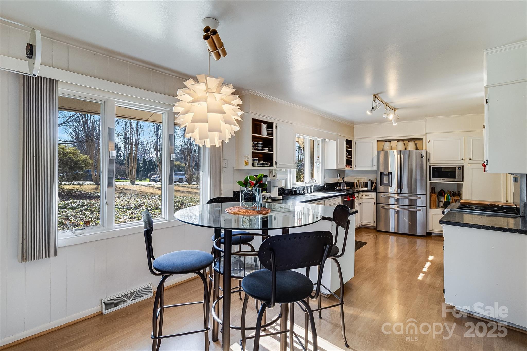 616 Robmont Road Charlotte, NC 28270 - Photo 15 of 38 a view of a dining room with furniture window and wooden floor