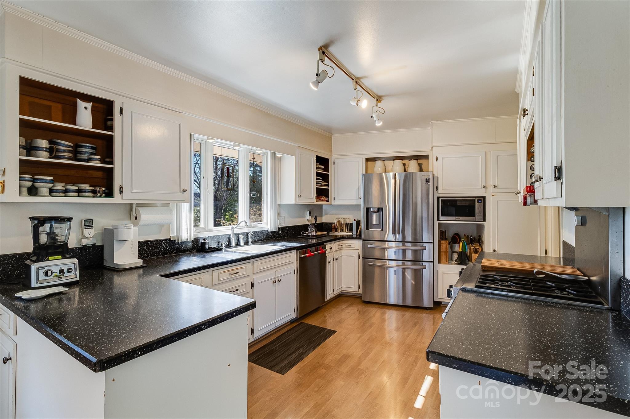 616 Robmont Road Charlotte, NC 28270 - Photo 18 of 38 a kitchen with a stove a sink and a refrigerator