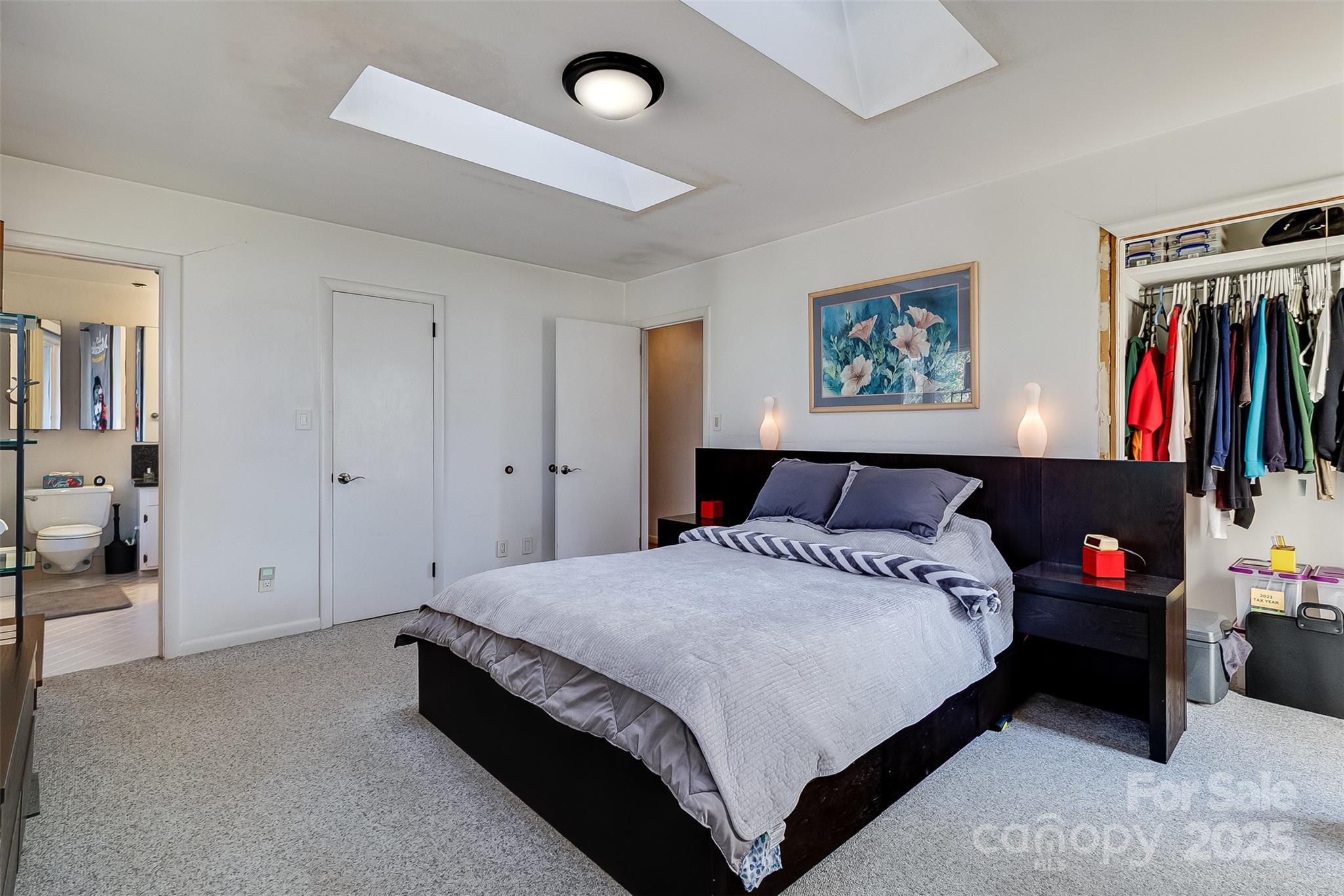 616 Robmont Road Charlotte, NC 28270 - Photo 28 of 38 a spacious bedroom with a bed and a book shelf