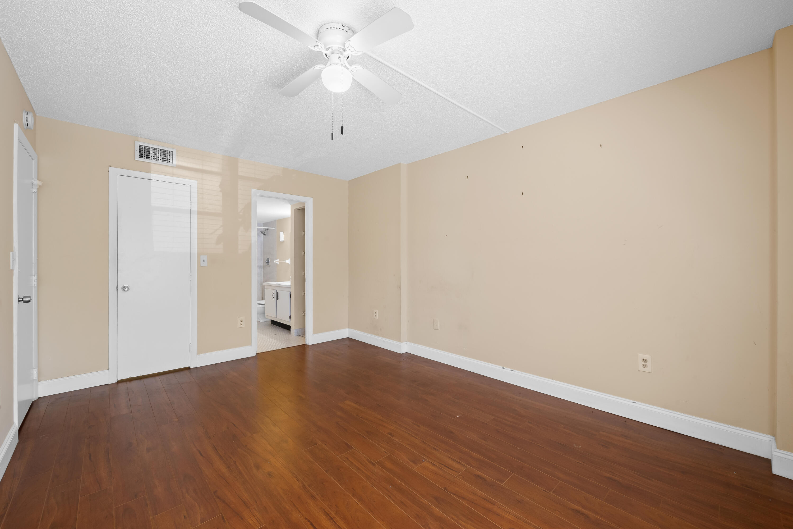 4156 Inverrary Drive, Unit 210 Lauderhill, FL 33319 - Photo 8 of 27 an empty room with wooden floor and ceiling fan