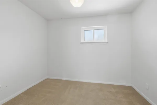 a room with a bed and a window