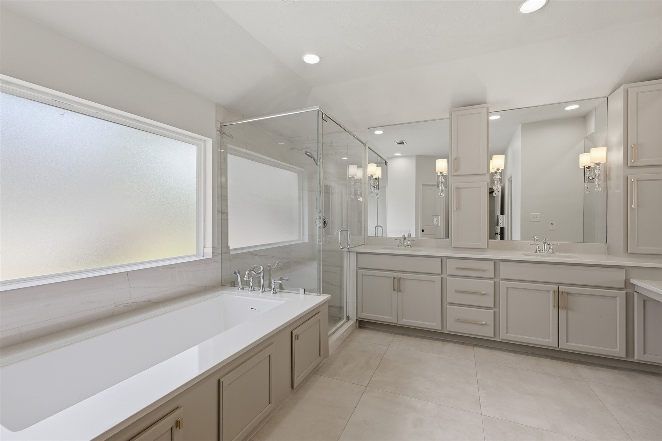24714 Hunters Hollow Drive Spring, TX 77380 - Photo 24 of 39 Incredible ensuite with a soaking tub, separate shower, double sinks, and a vanity area.