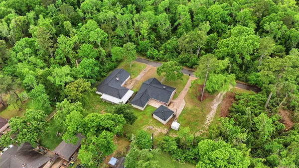 an aerial view of a house with a yard