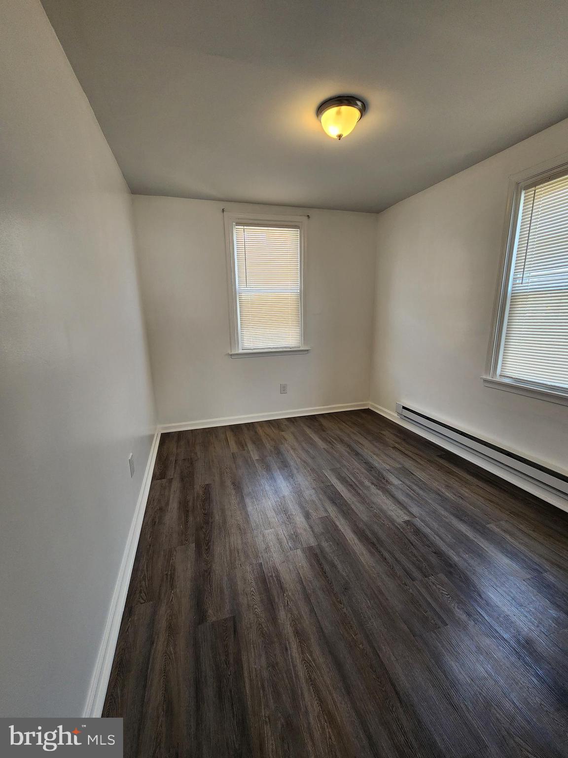 89 Sparks Street Philadelphia, PA 19120 - Photo 21 of 37 an empty room with wooden floor and windows