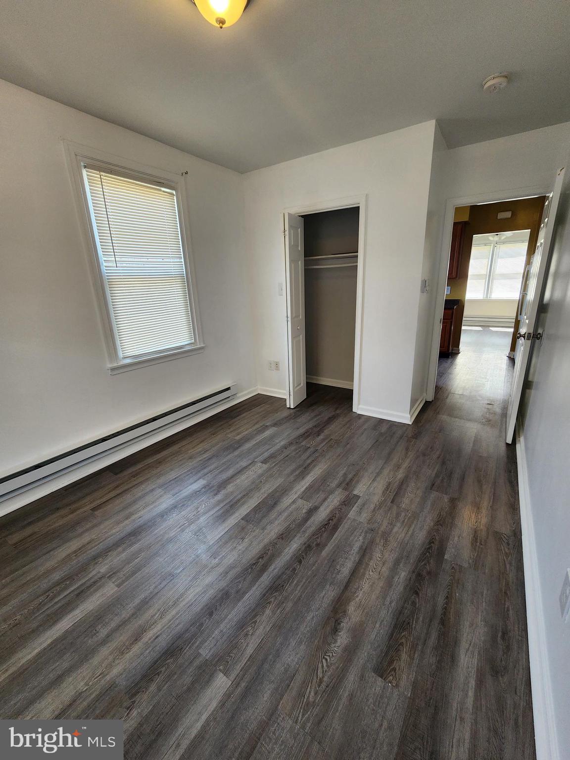 89 Sparks Street Philadelphia, PA 19120 - Photo 22 of 37 a view of an empty room with wooden floor and a window