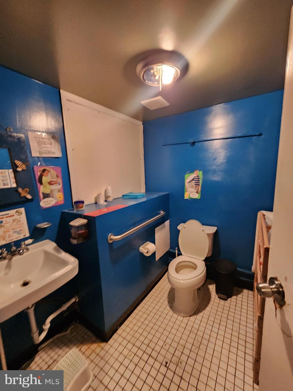 89 Sparks Street Philadelphia, PA 19120 - Photo 29 of 37 a bathroom with a sink mirror and toilet