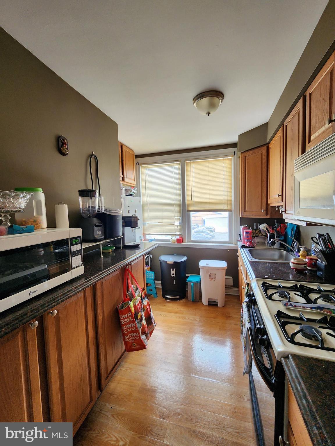 89 Sparks Street Philadelphia, PA 19120 - Photo 6 of 37 a kitchen with stainless steel appliances a stove top oven and a refrigerator
