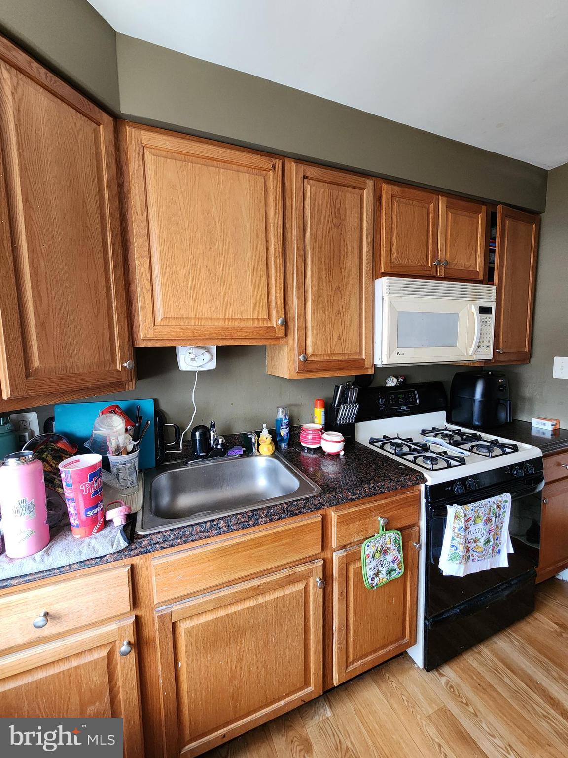 89 Sparks Street Philadelphia, PA 19120 - Photo 7 of 37 a kitchen with stainless steel appliances granite countertop a stove a sink dishwasher and cabinets with wooden floor
