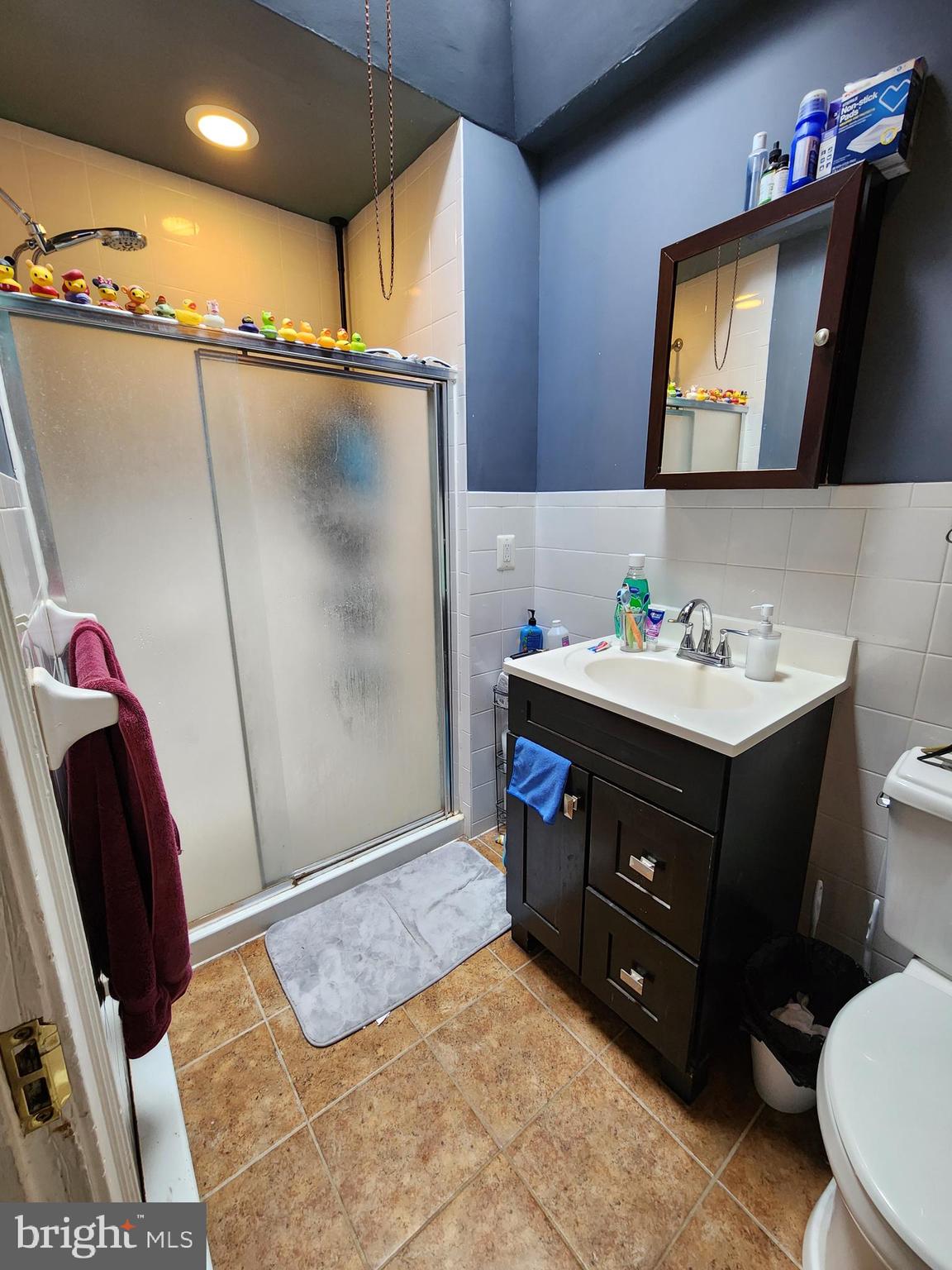 89 Sparks Street Philadelphia, PA 19120 - Photo 8 of 37 a bathroom with a sink vanity and a mirror