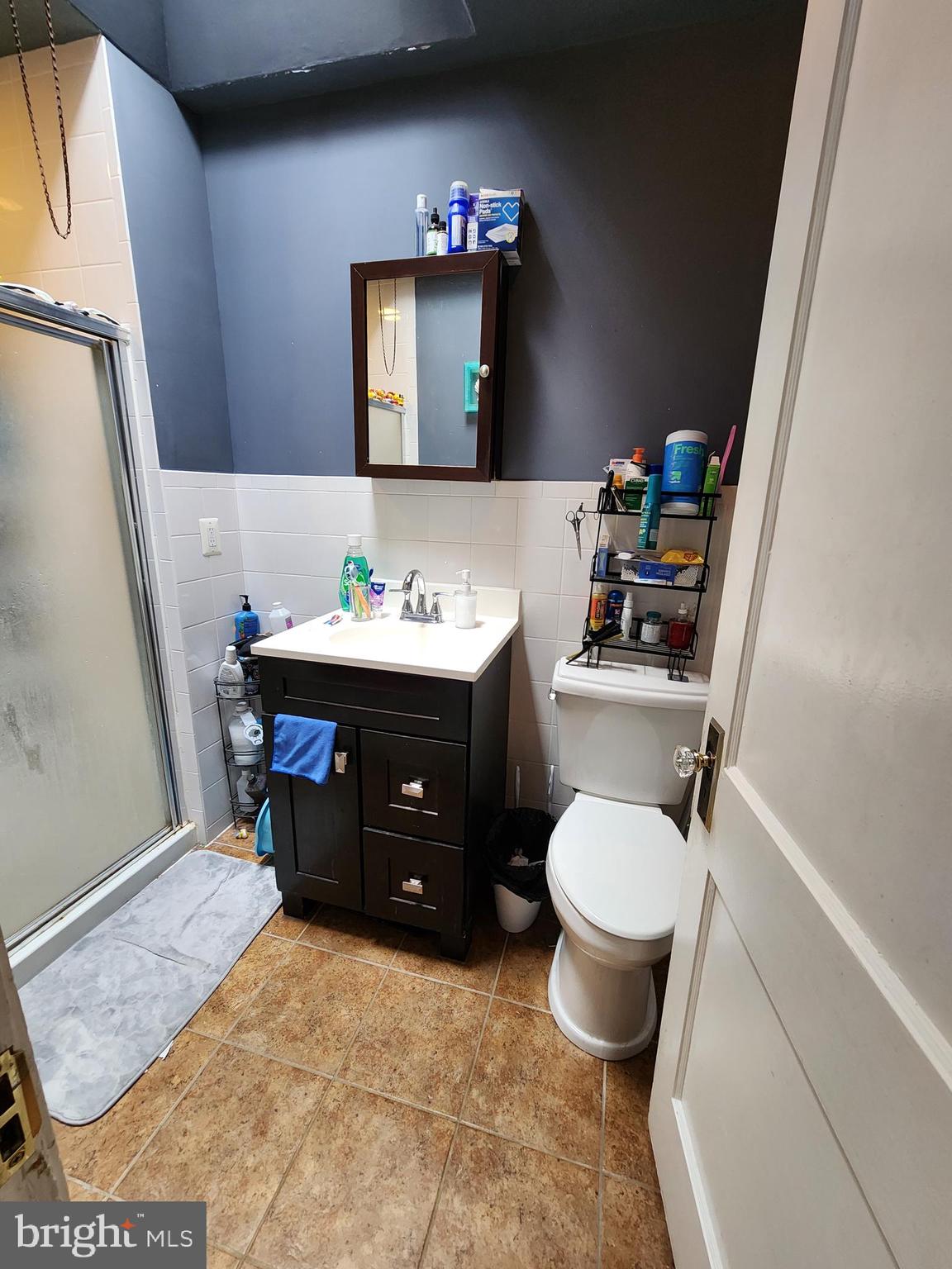89 Sparks Street Philadelphia, PA 19120 - Photo 9 of 37 a bathroom with a sink toilet and mirror