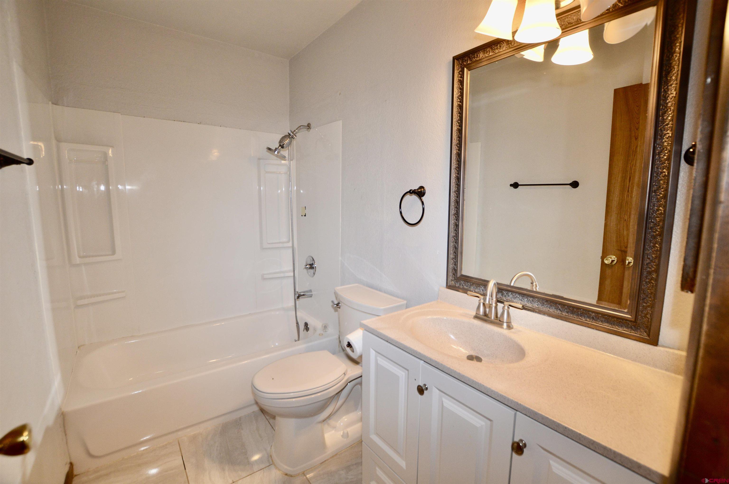 1005 West Denver Avenue, Unit G4 Gunnison, CO 81230 - Photo 16 of 21 a bathroom with a sink a toilet and shower