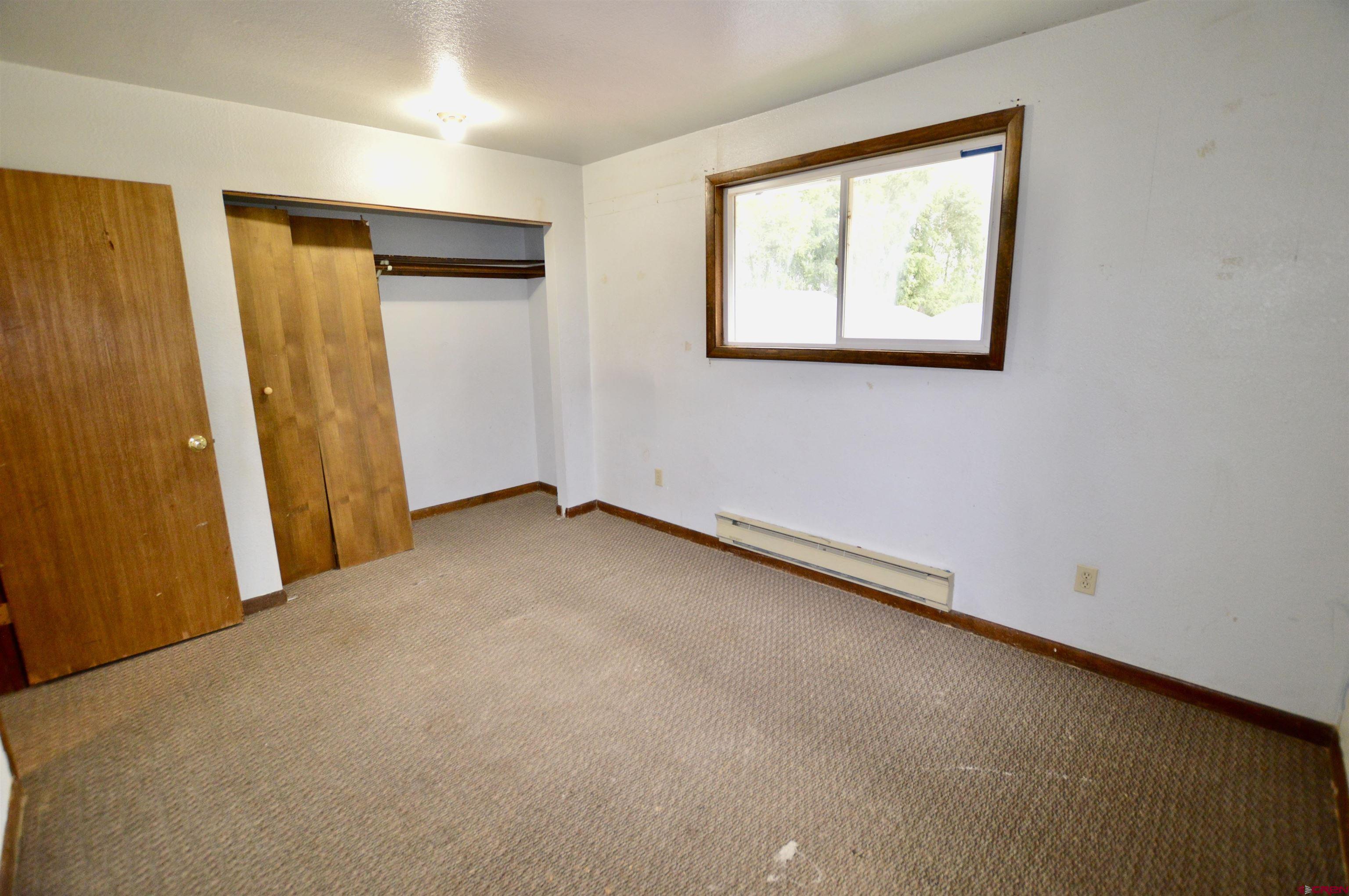 1005 West Denver Avenue, Unit G4 Gunnison, CO 81230 - Photo 19 of 21 an empty room with windows