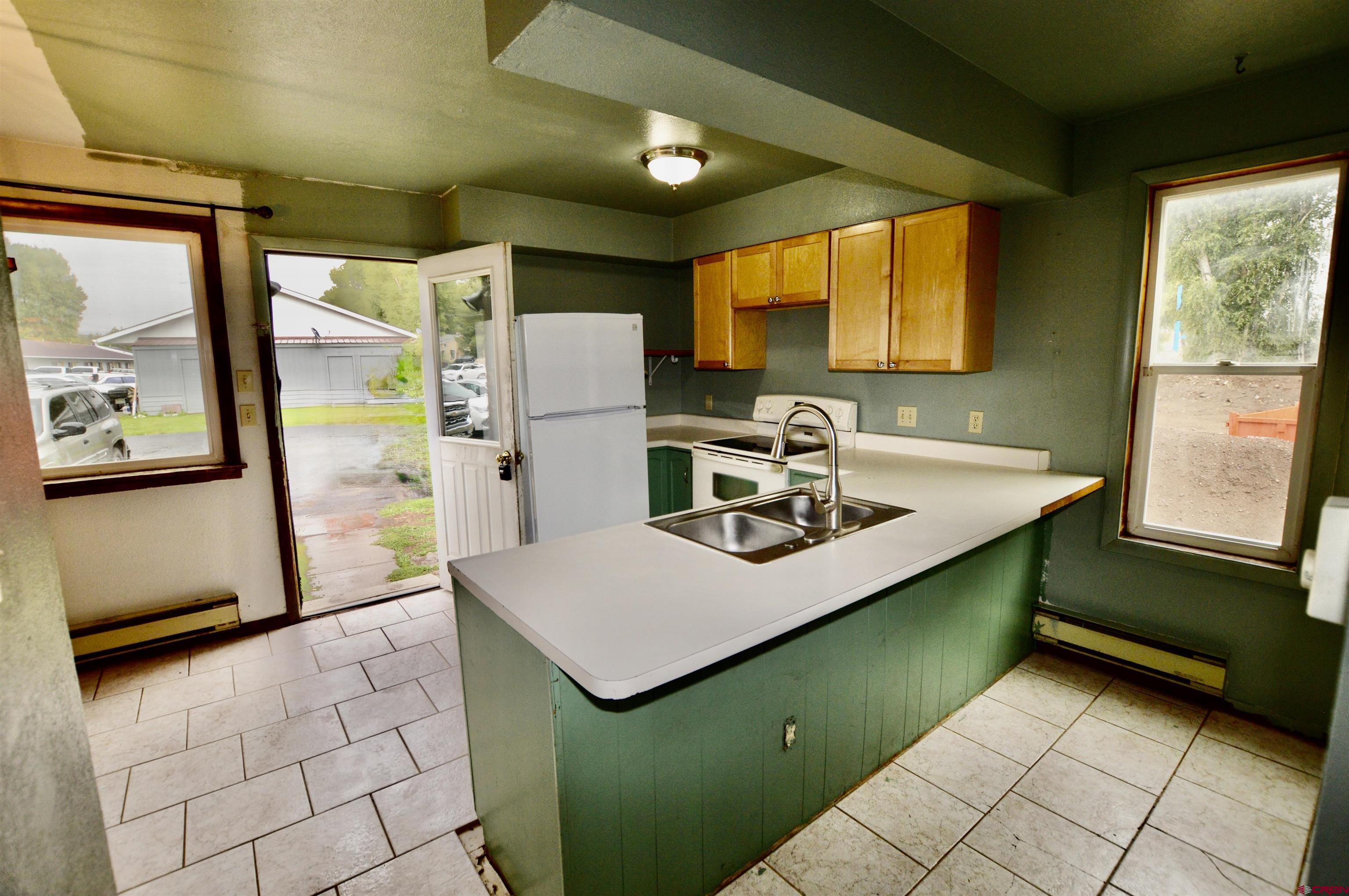 1005 West Denver Avenue, Unit G4 Gunnison, CO 81230 - Photo 6 of 21 a kitchen with a refrigerator and a sink