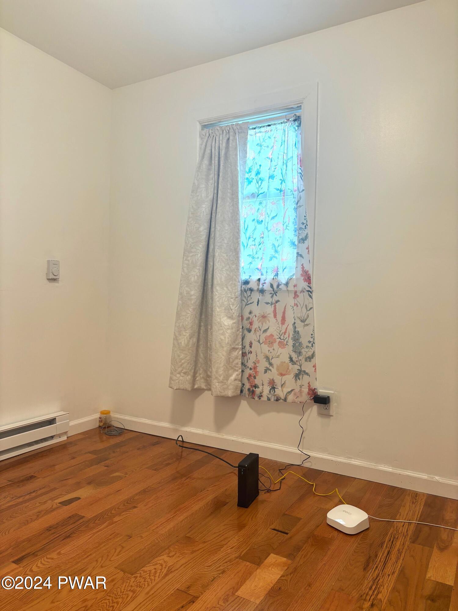 1113 Bracts Road Effort, PA 18330 - Photo 10 of 27 an empty room with wooden floor and windows