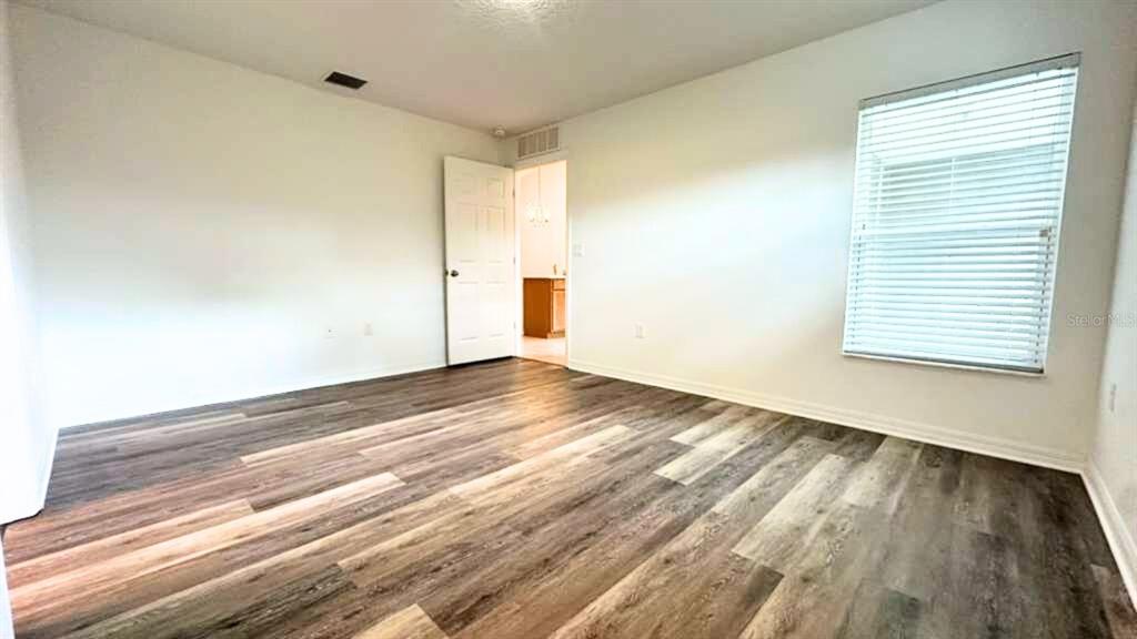 2 Ryapple Lane, Unit B Palm Coast, FL 32164 - Photo 13 of 13 a view of empty room with wooden floor and fan